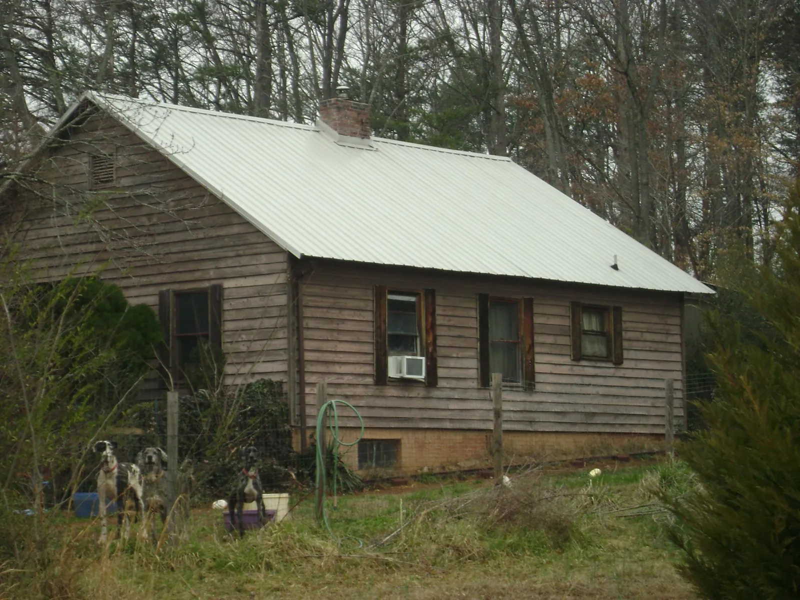 White metal roof on an old wood sided farmhouse, from a Metal Roof Installation job in Glen Carbon